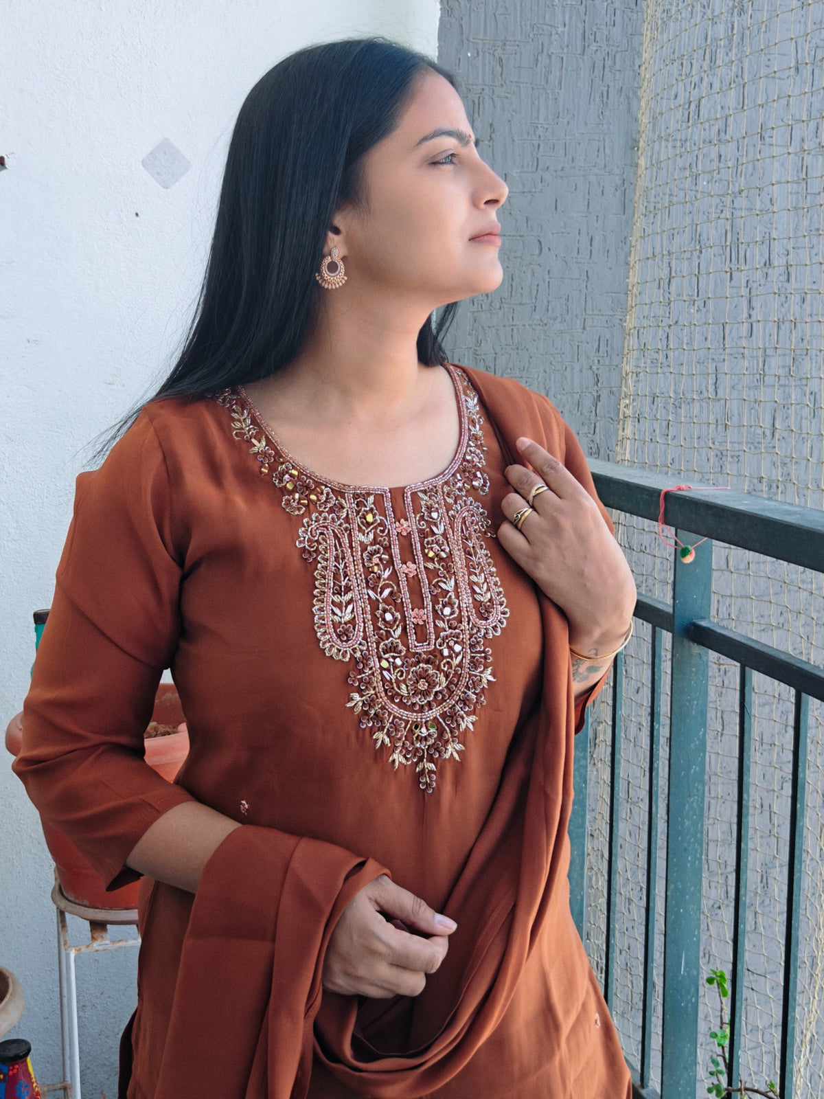 Rust embroidered suit, balcony styling